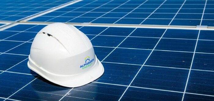 DNO Application for Solar: What UK Businesses Need to Know a white hard hat on a solar panel - DNO-application-for-solar